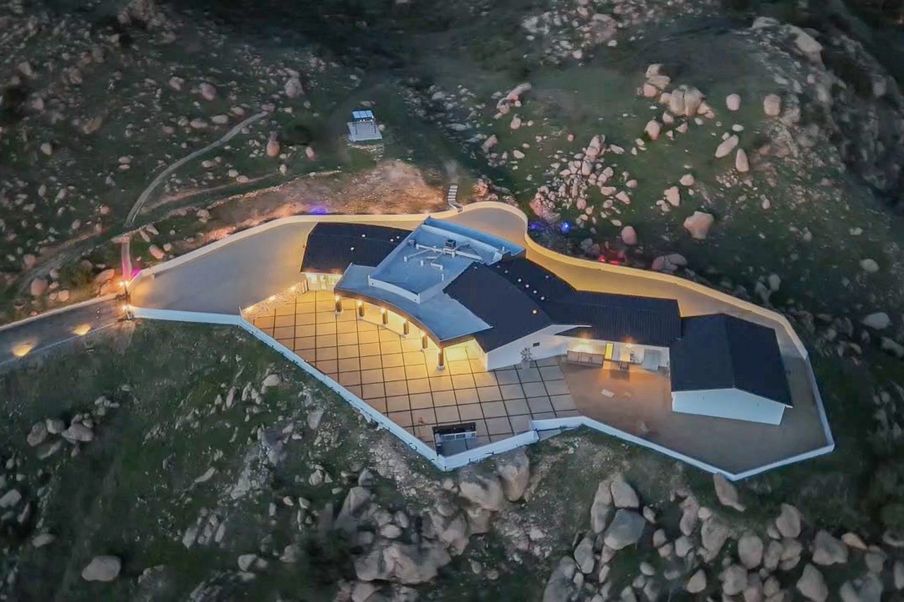 Aerial view of Golden Ridge Estate, a modern architectural compound on a 31-acre Bell Canyon hilltop at twilight